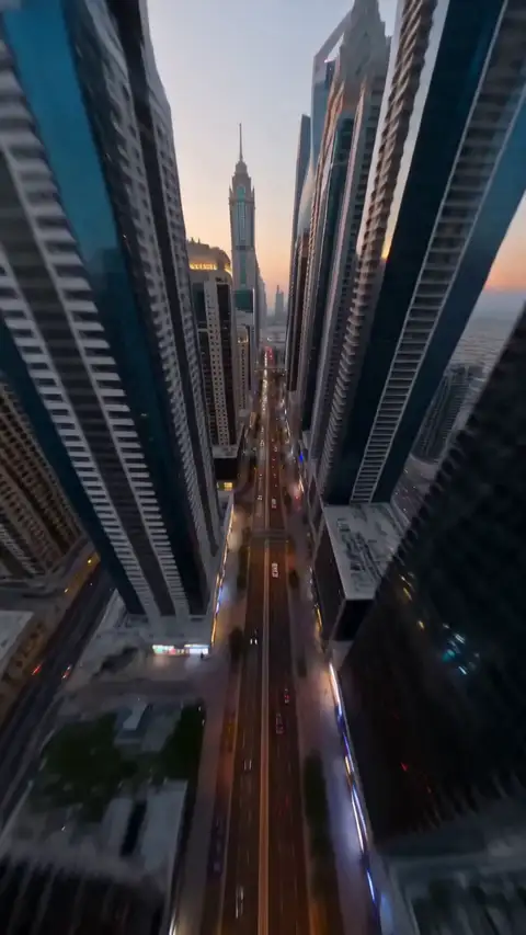 A drone weaves between Dubai towers at dusk, through a lit corridor, into a penthouse overlooking the skyline